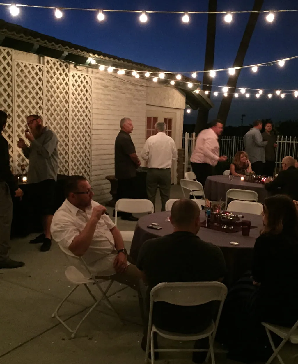 Outdoor evening reception with string lights at Orangecrest Club