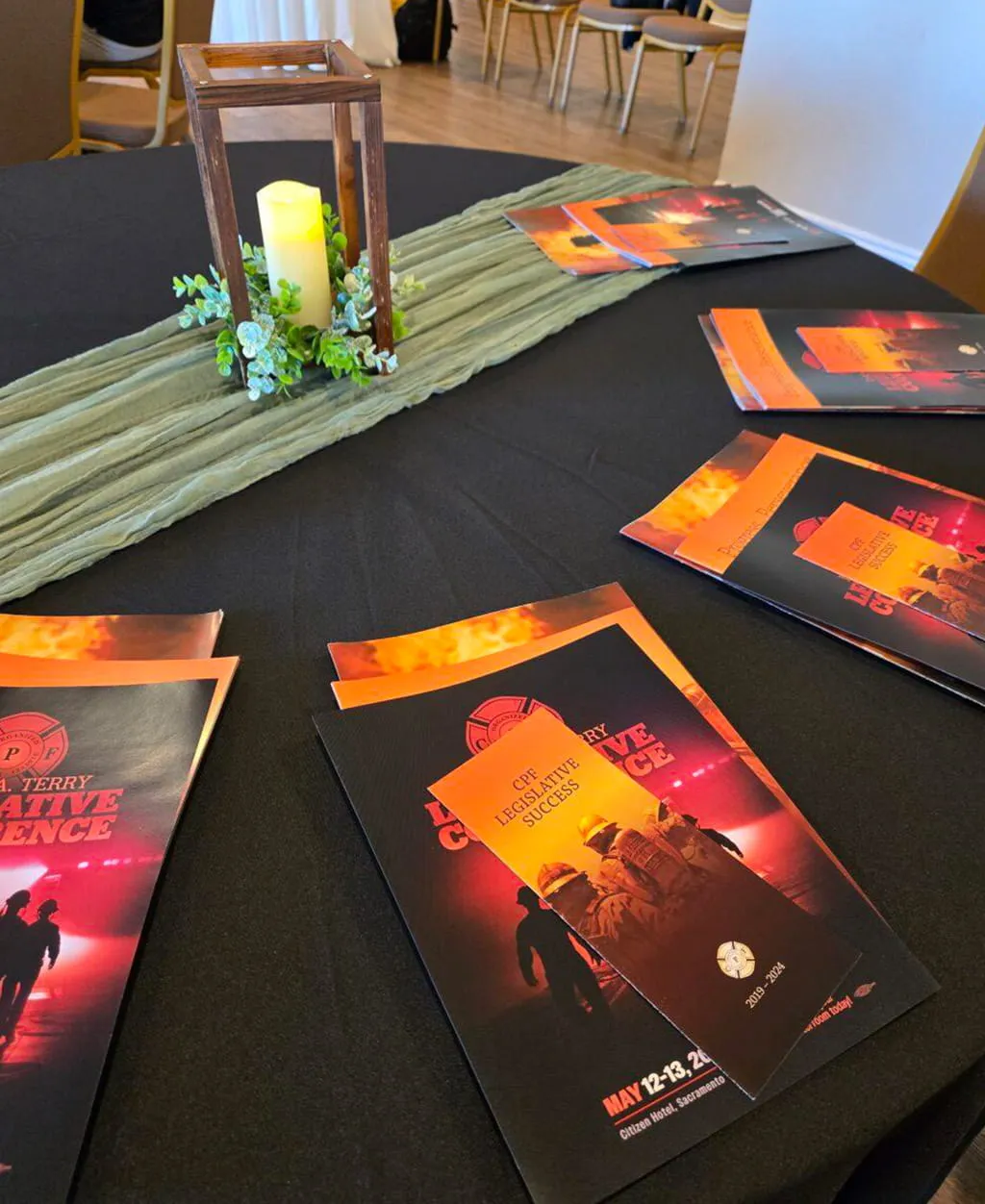 Corporate gathering table setup with programs and candle centerpiece at Orangecrest Club