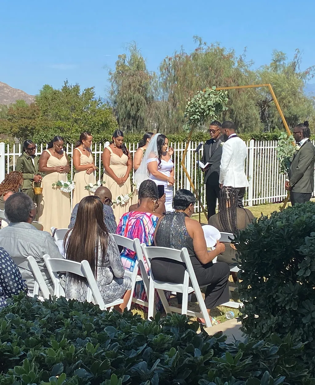 Outdoor wedding ceremony setup with guests and mountain view at Orangecrest Club