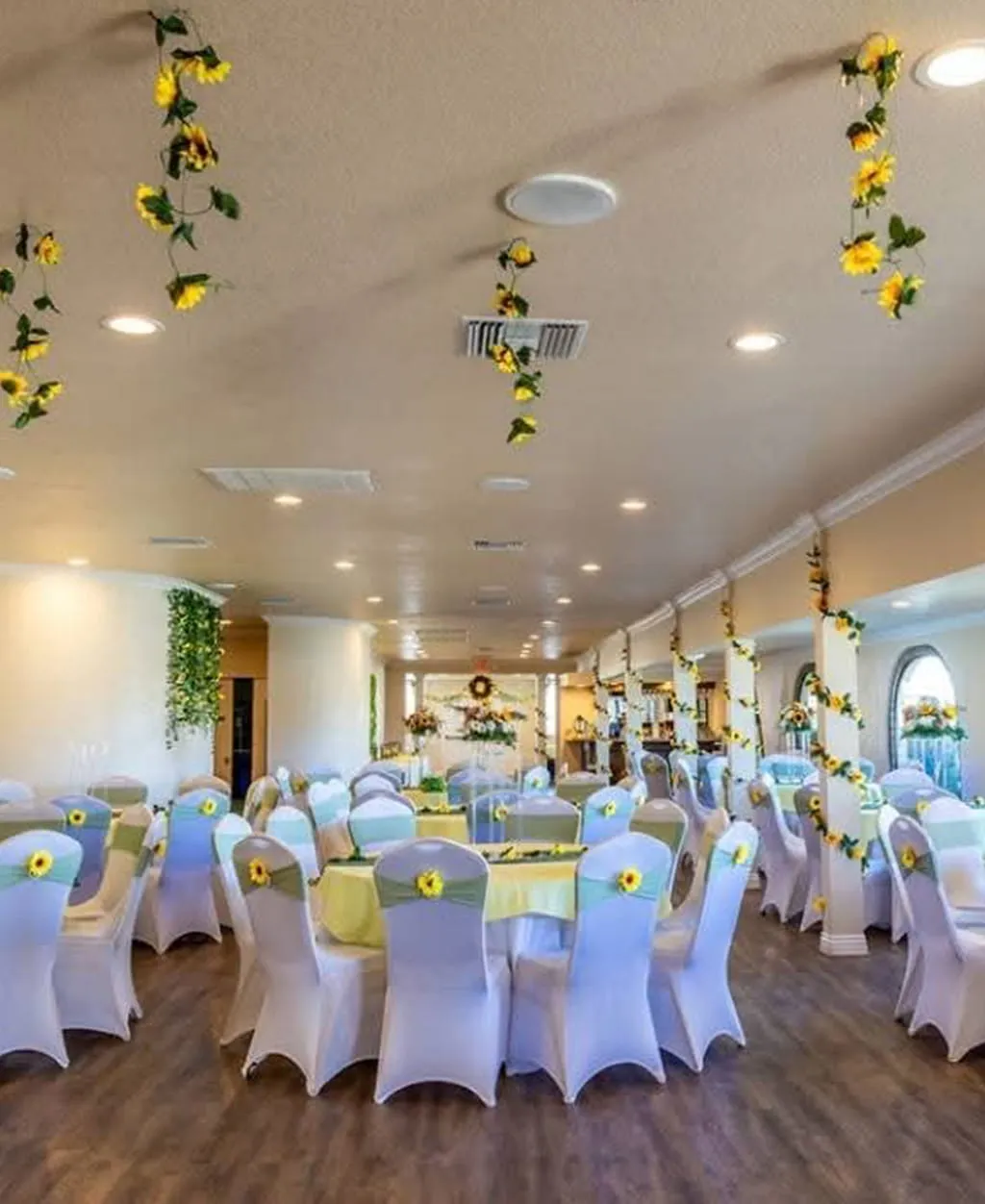 Sunflower themed event hall with yellow and green decor at Orangecrest Club
