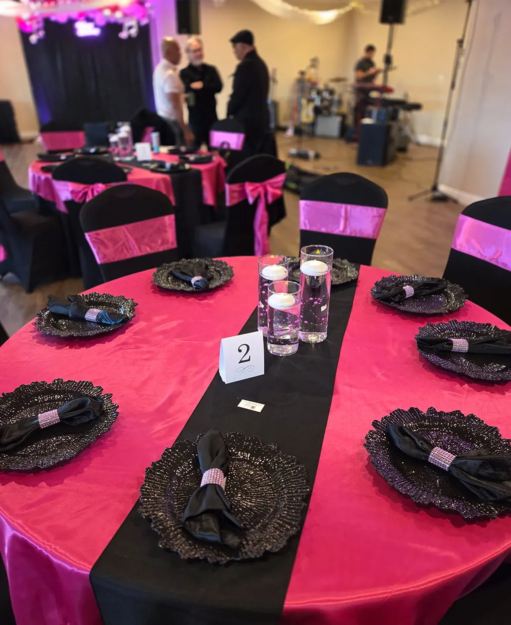 Pink and black themed table setup for celebration at Orangecrest Club