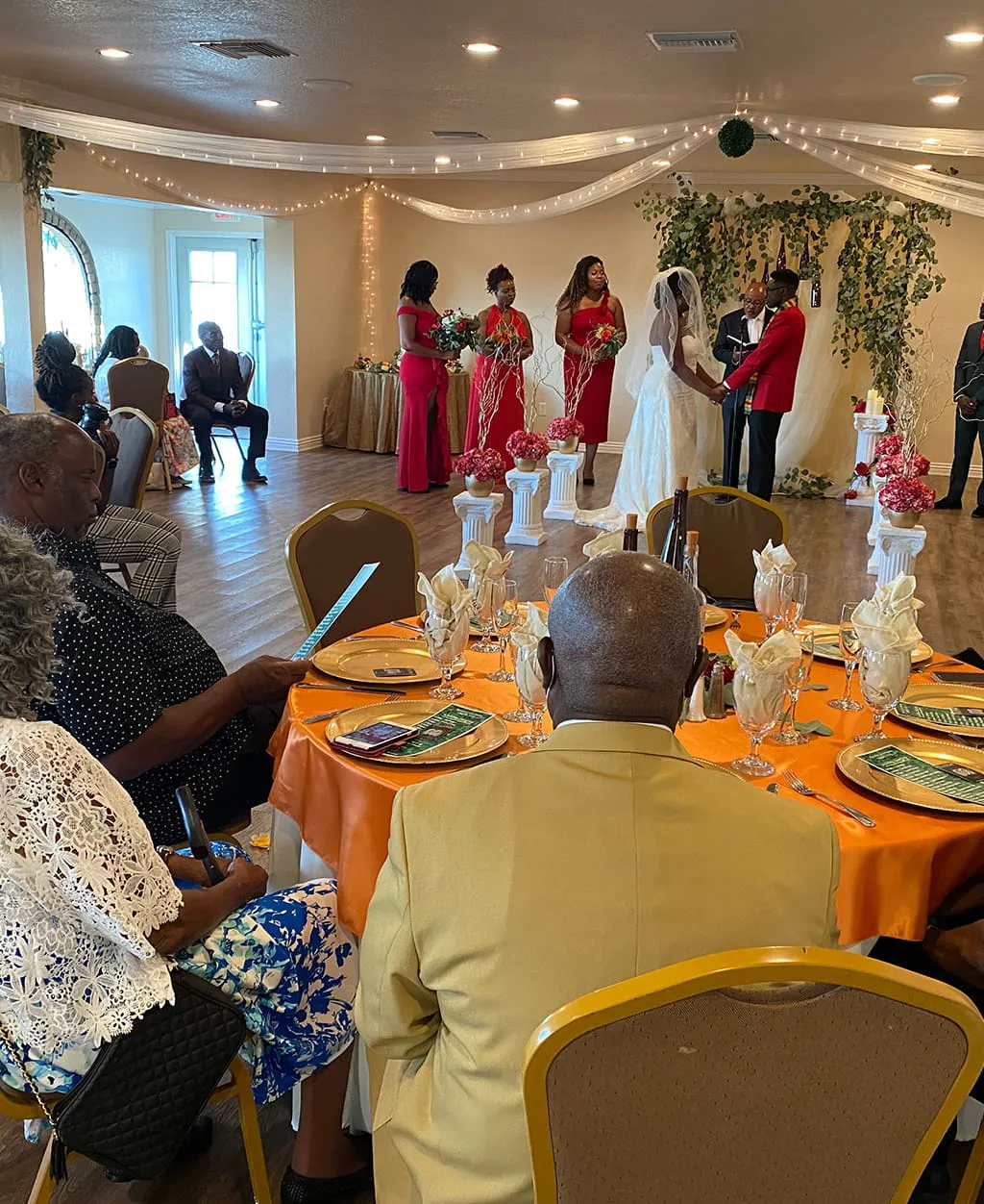 Wedding reception ceremony with guests seated at decorated tables at Orangecrest Club