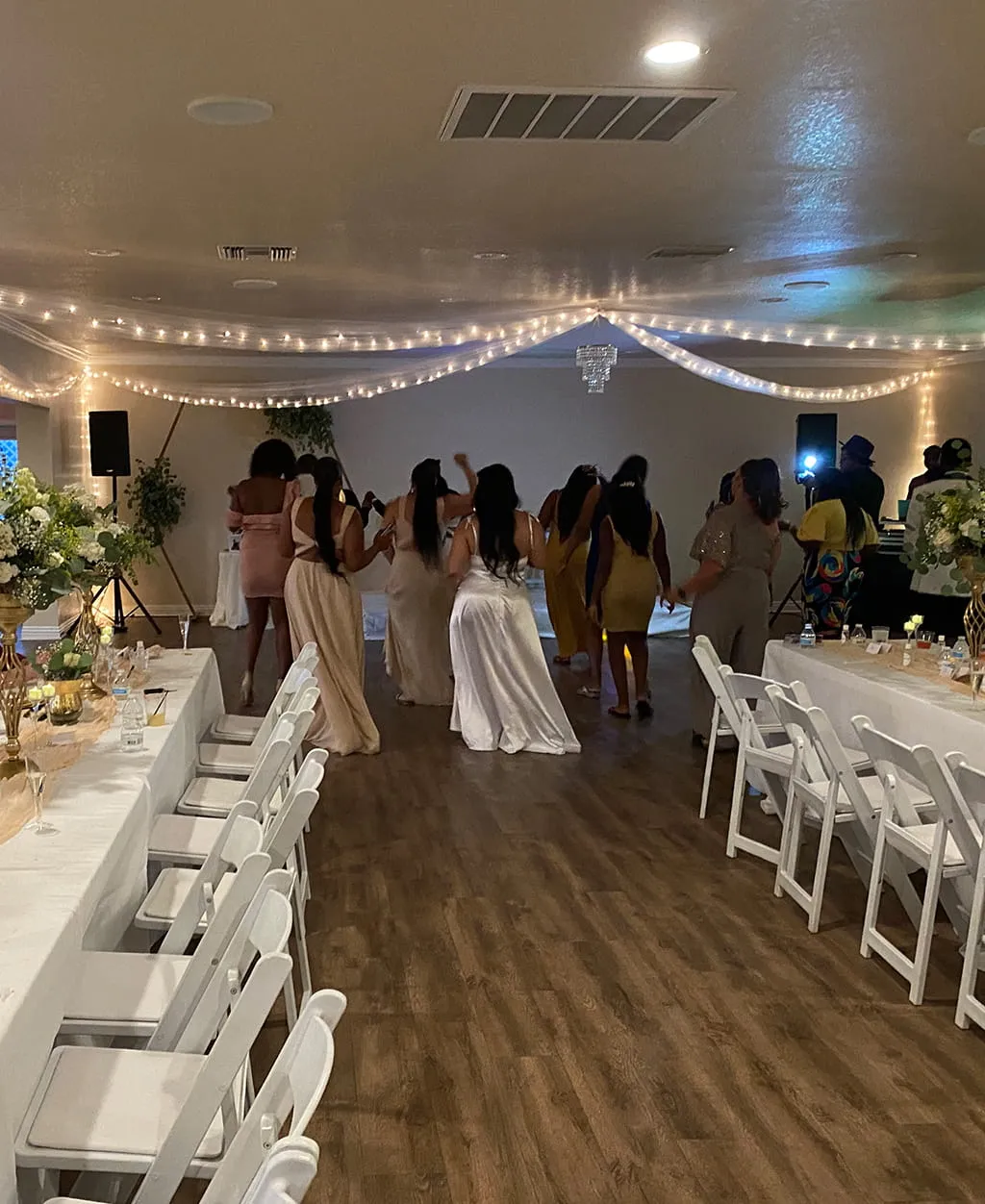 Wedding head table and reception setup with floral arrangements at Orangecrest Club
