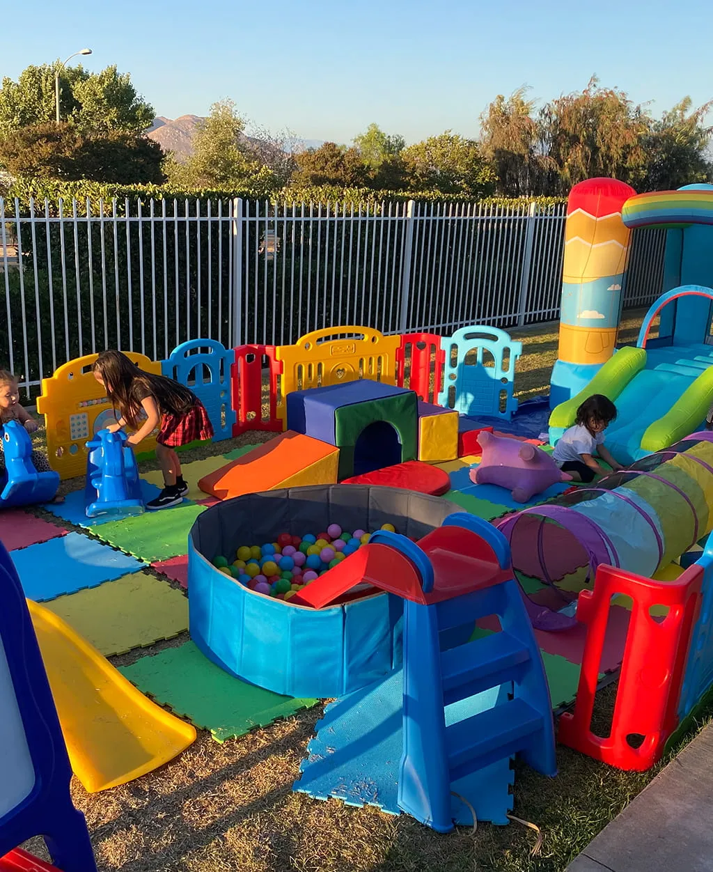 Kids play area with inflatable and activity zone at Orangecrest Club outdoor space