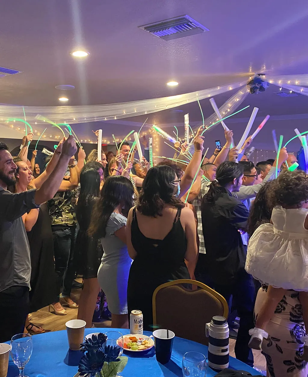 Wedding dance floor celebration with guests and party lighting at Orangecrest Club