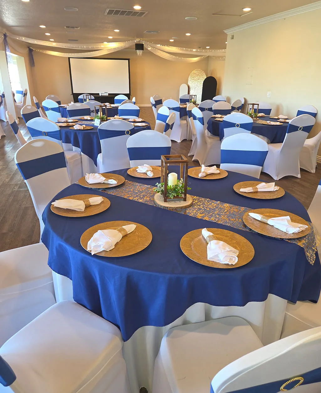 Blue and gold themed event table setup with elegant decor at Orangecrest Club