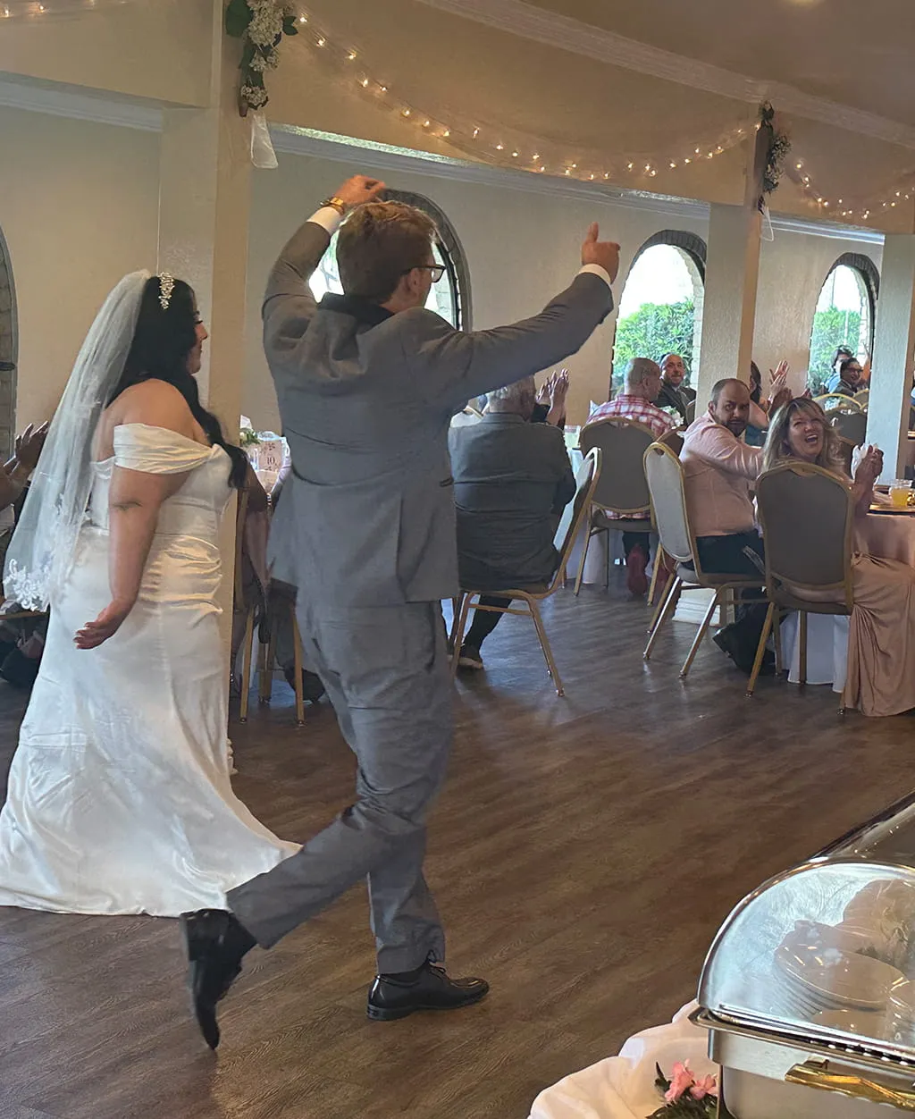 Bride and groom grand entrance during wedding reception at Orangecrest Club
