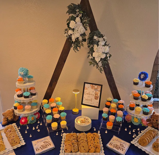 Baby shower dessert table with cupcakes, cookies, and decorative backdrop at Orangecrest Club private event venue