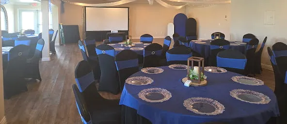Corporate event setup with blue table linens and banquet seating inside Orangecrest Club venue