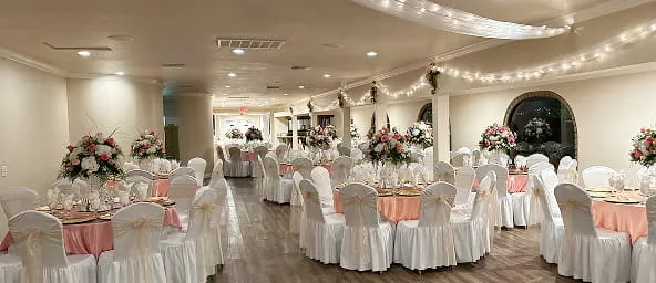 Elegant event hall with decorated tables floral centerpieces and ambient lighting at Orangecrest Club venue