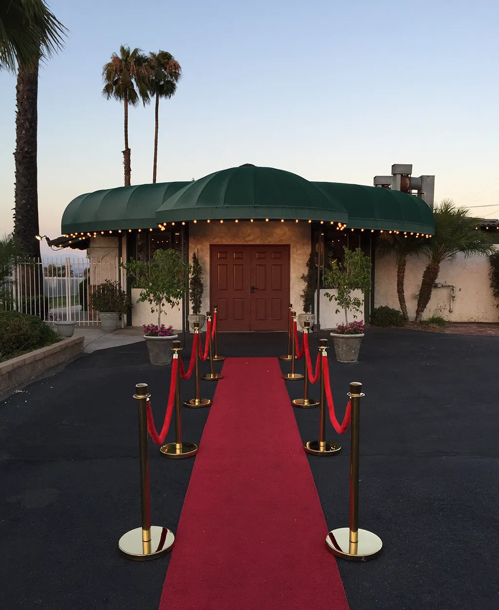 Main entrance of Orangecrest Club with red carpet walkway and rope stanchions for event arrivals