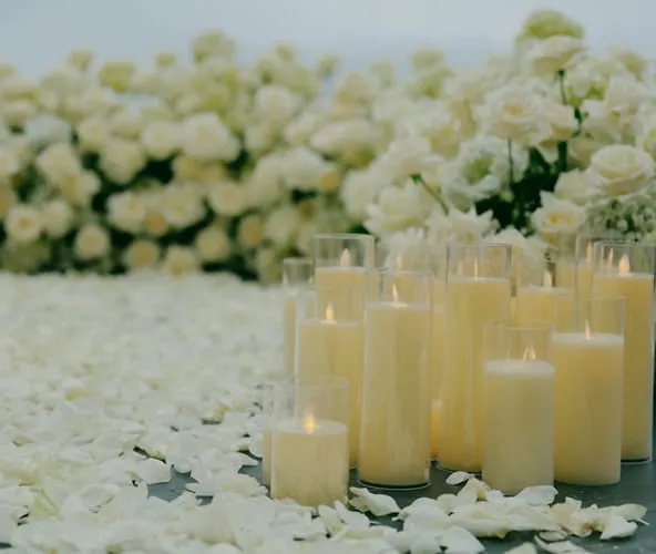 Memorial candle display with white flowers and elegant decor for celebration of life event at Orangecrest Club