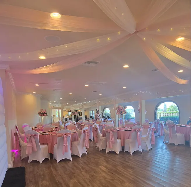 Elegant pink themed reception setup with draped ceiling and banquet seating at Orangecrest Club