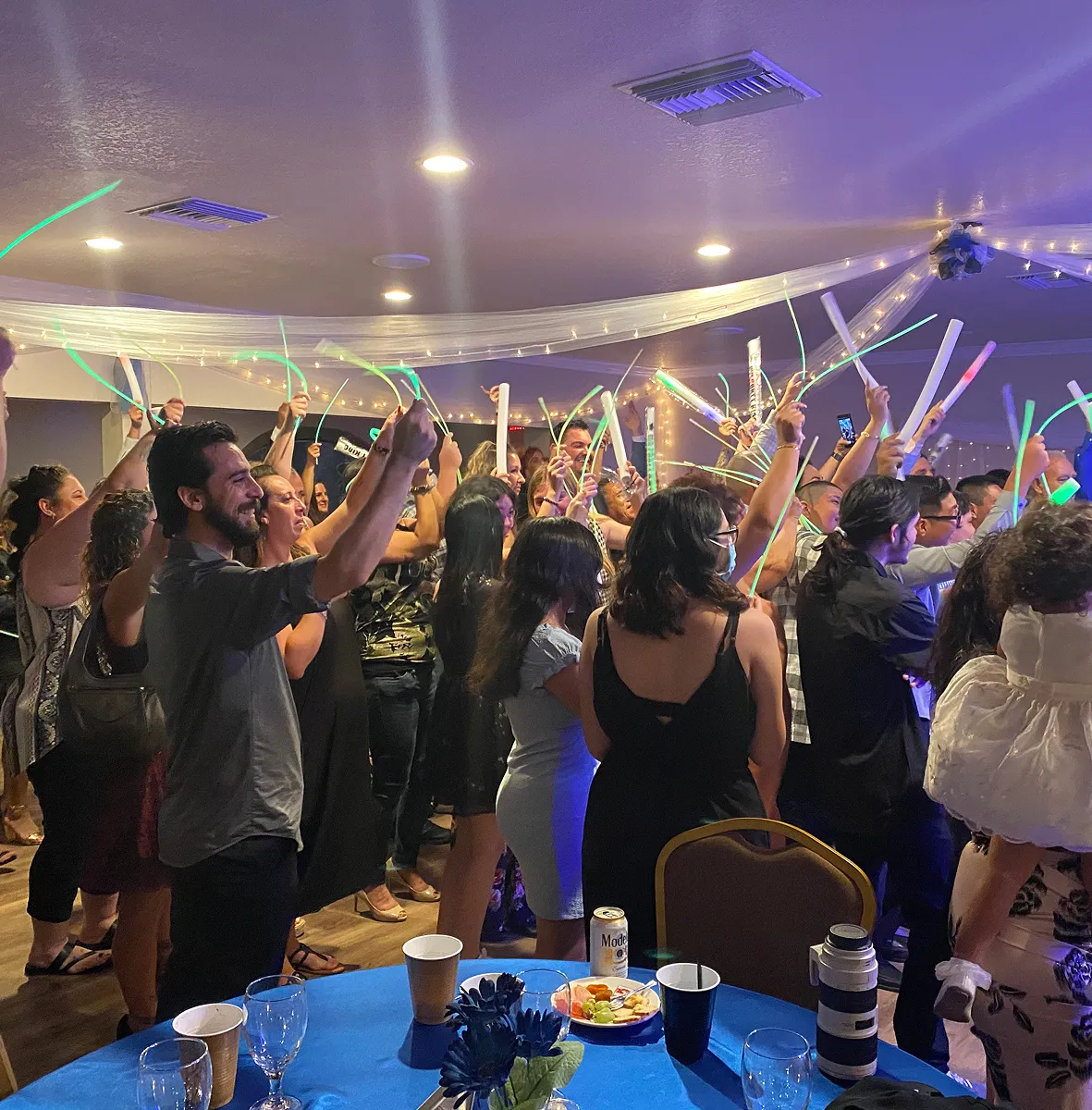 Guests dancing with glow sticks on lively private party dance floor at Orangecrest Club event venue