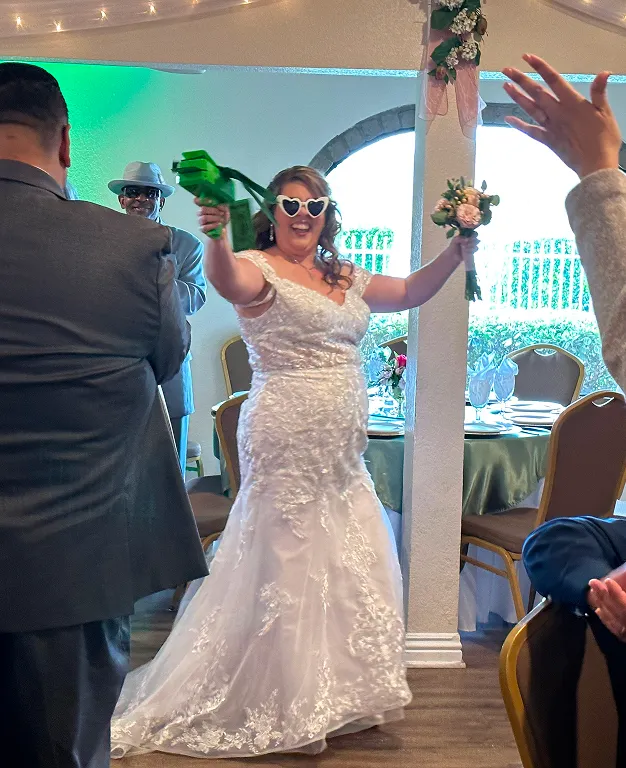 Bride celebrating during wedding reception with guests inside Orangecrest Club private event venue